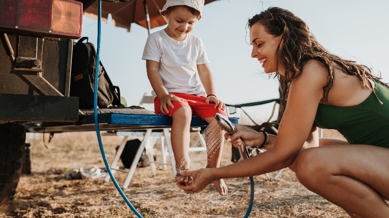 Woman cleaning a child's feet