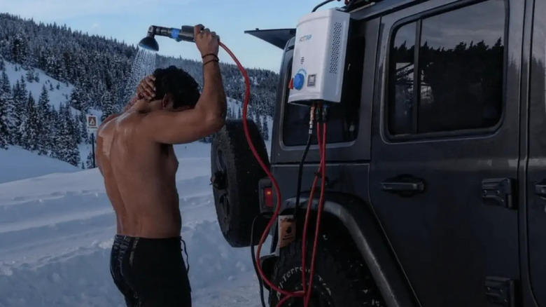 Man showering outside Jeep