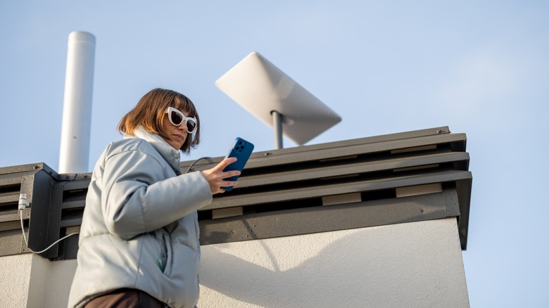 Woman installing Starlink dish