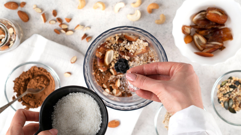 person making energy balls using mini blender