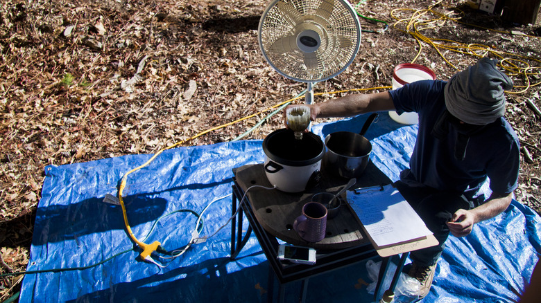 person making food inside the rice cooker