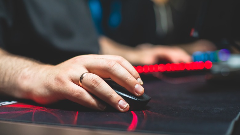 gamer's hand using mouse and keyboard