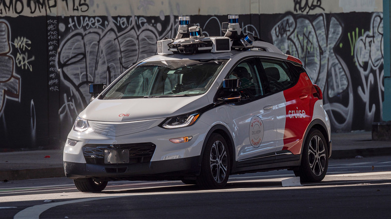 A Cruise robotaxi in its signature red and white coat.