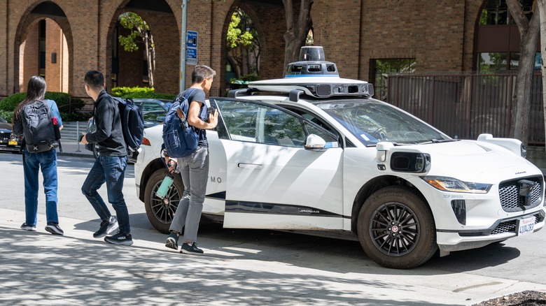 People outside a self-driving car