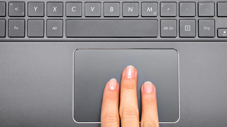 three fingers swiping trackpad