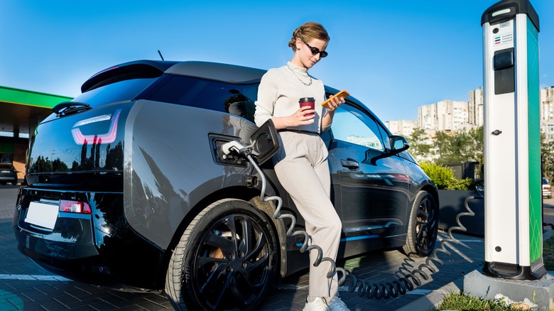 Woman charging an electric car.