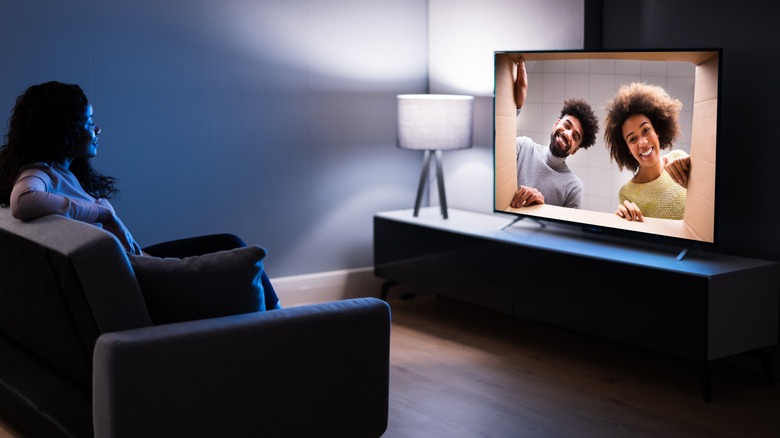 woman watching TV in dark room