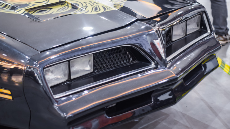 The hood of a gray Pontiac Firebird Trans Am.