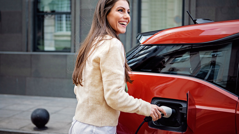 Woman charging an electric car.