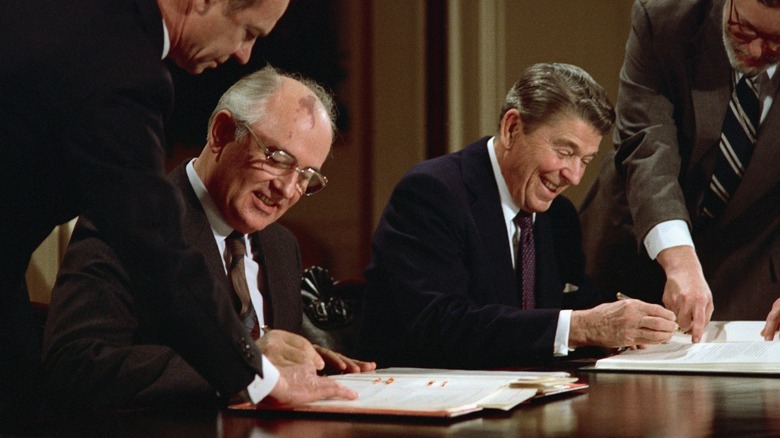 Reagan and Gorbachev signing a treaty