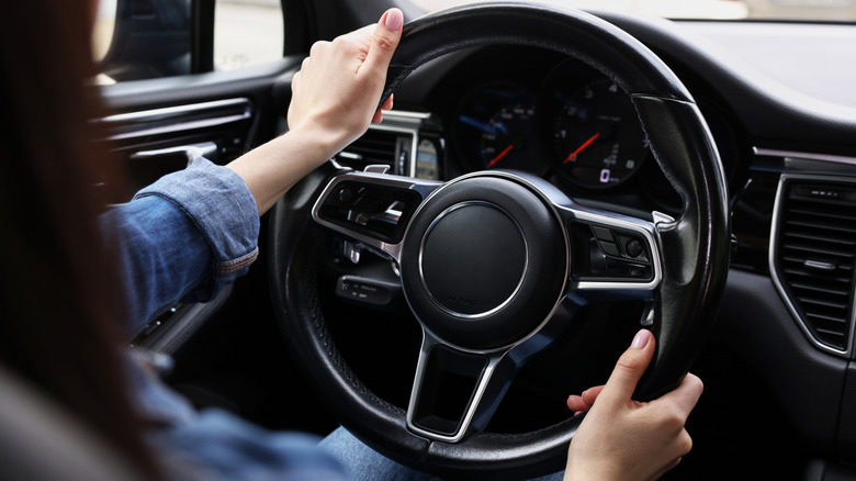 Woman holding the steering wheel