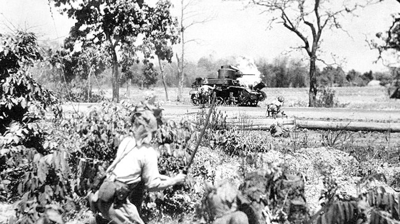 soldiers observe an M3 Stuart