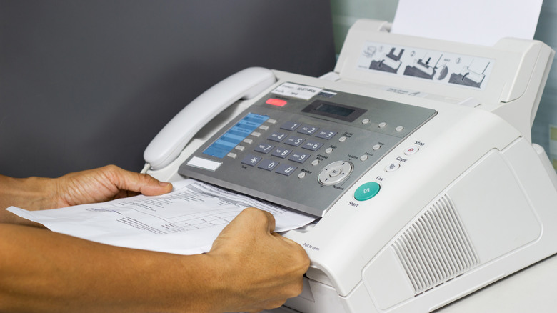 using fax machine in office