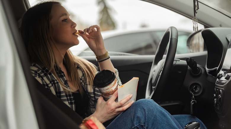 Woman eating while driving