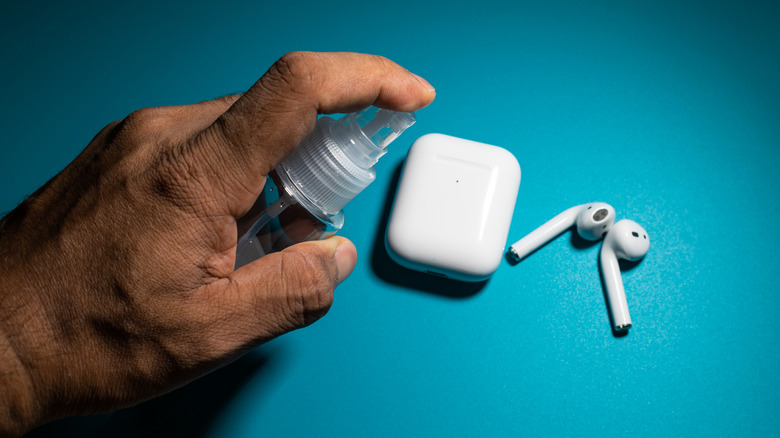 Man cleaning AirPods