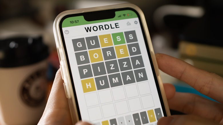 person playing Wordle smartphone