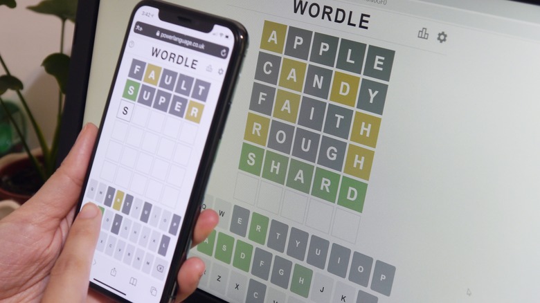 person playing Wordle on smartphone