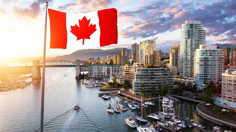 Canadian flag over city skyline