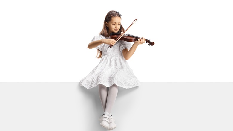 little girl playing a violin