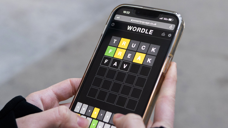 A person playing Wordle on their phone.