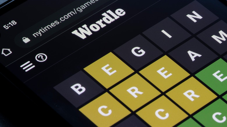 Playing popular online puzzle game Wordle on a phone.