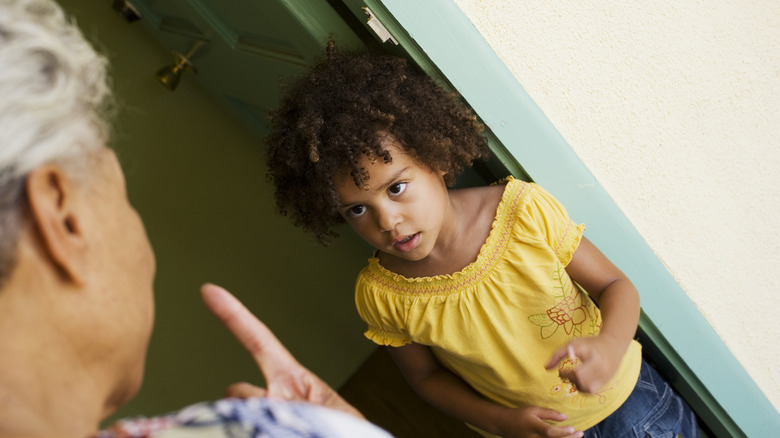 older woman scolding little girl