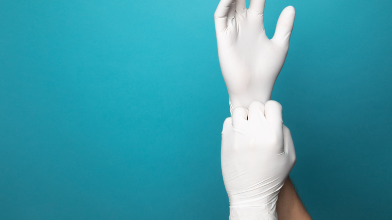 white latex glove on two hands