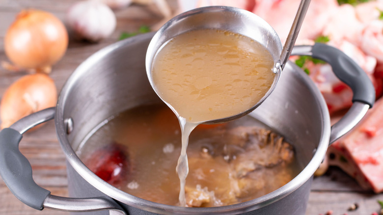saucepan with bouillon in a ladle