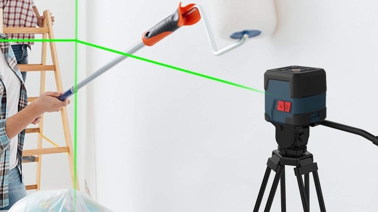 laser leveling tool in front of white wall