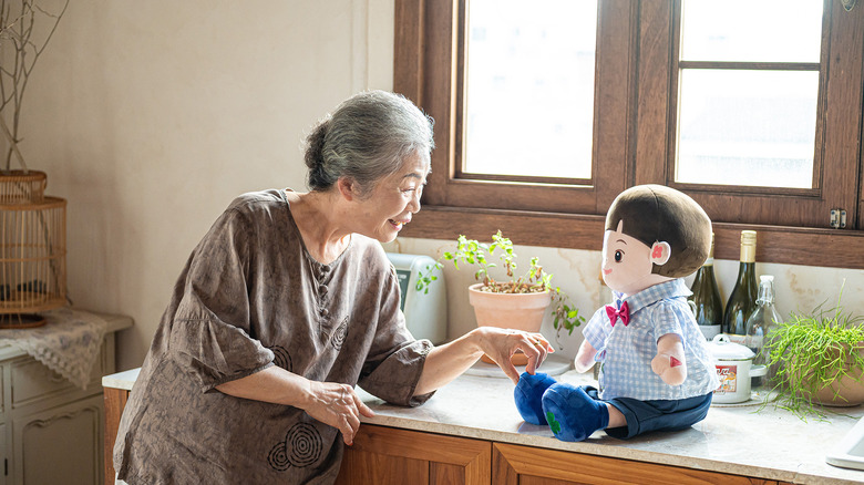 Woman interacting with a doll powered by conversational AI.