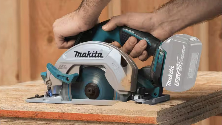 Circular saw cutting through wood