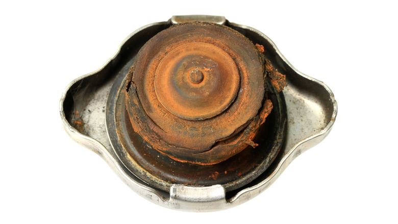 Damaged radiator cap showing rust and split seals