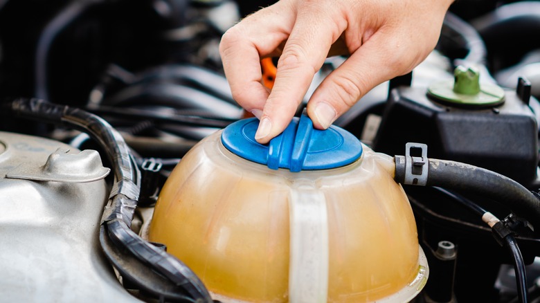 Man opening the coolant reservoir