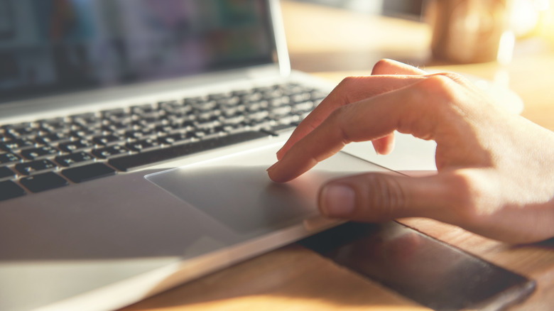 man using laptop touchpad