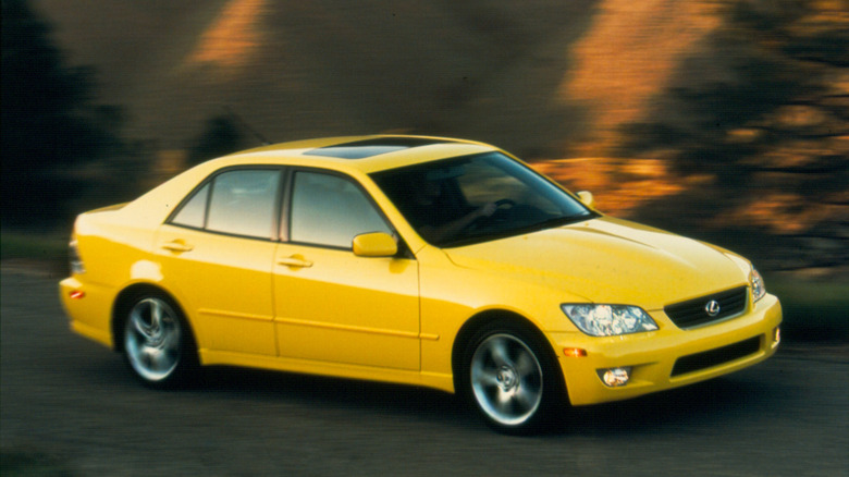 Yellow Lexus IS 300 driving, front-right three-quarter view