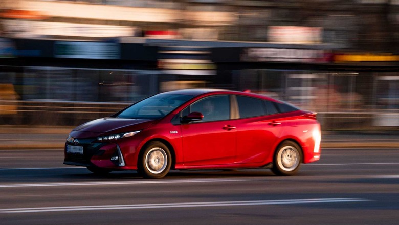 Red Toyota Prius driving