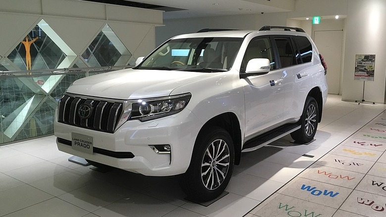 White 2017 Toyota Land Cruiser Prado parked in a dealership showroom