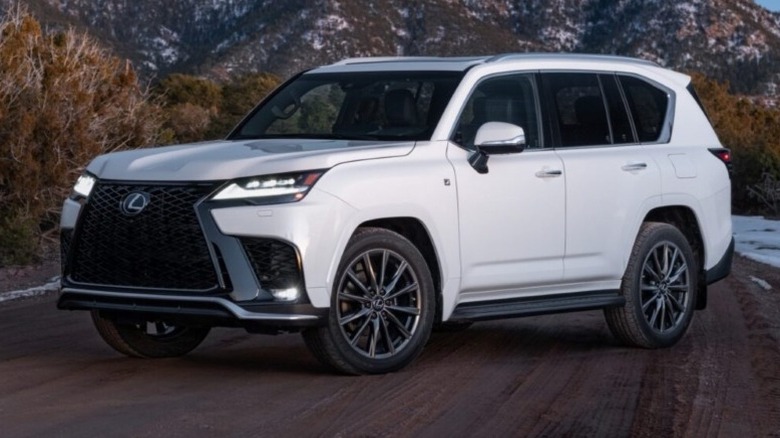 Lexus LX 600 F Sport parked on a road with mountains in the background