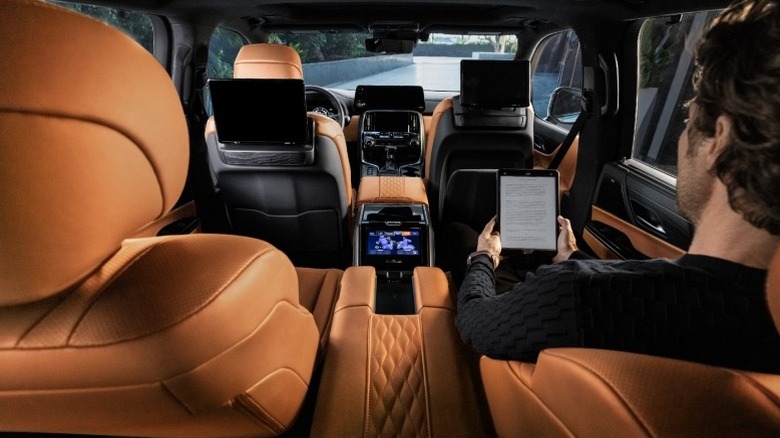 Lexus LX Ultra Luxury interior showing the second-row captain's chairs and infotainment system