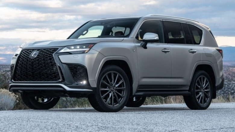 Front 3/4 shot of a parked Lexus LX 600 F Sport with blue sky background