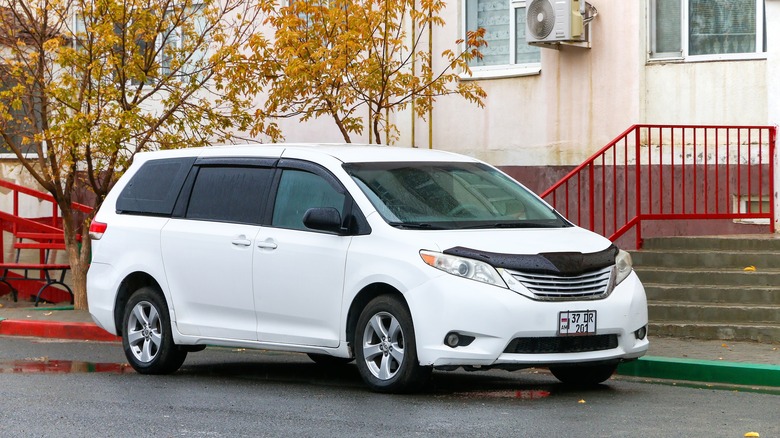 White Toyota Sienna parked at a curb