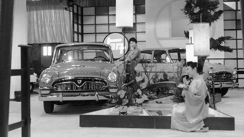 A black and white photo of a vintage Toyopet Crown exhibit