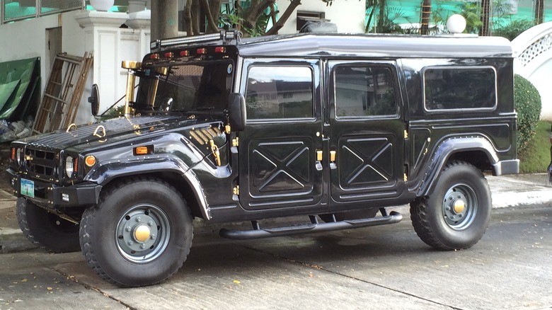 A black Toyota Mega Cruiser with the rear hardtop installed