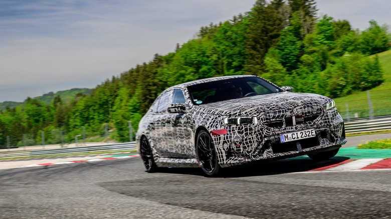 A camouglaged 2025 BMW M5 on the track