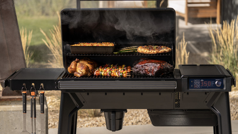 Grilling meat and vegetables on a Traeger Woodridge grill.