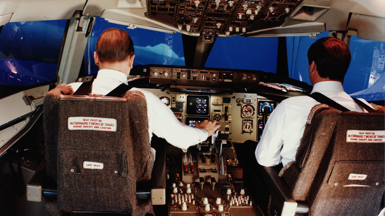 Pilots training in flight simulator