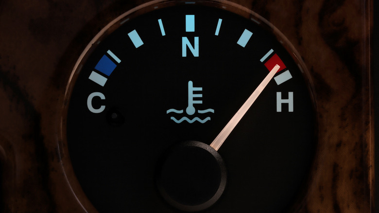 Car temperature gauge showing excess temperature