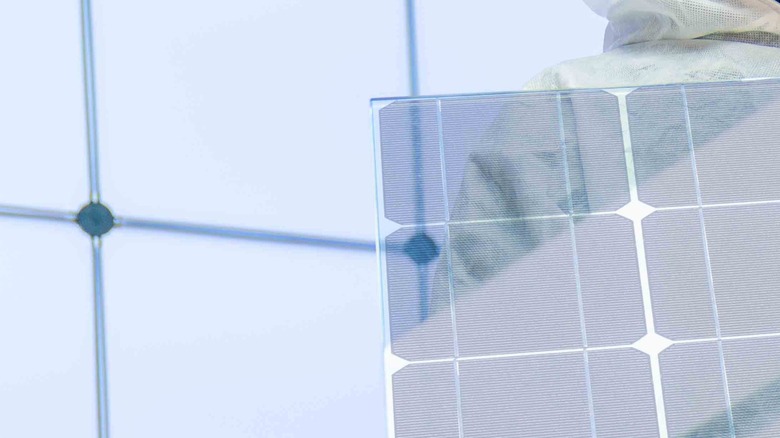 Transparent solar panel being held up