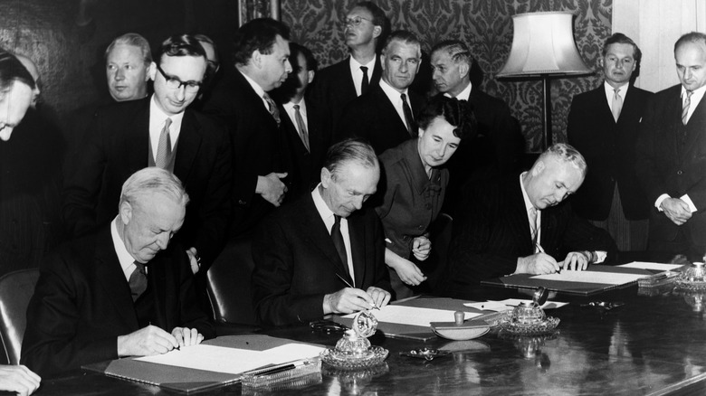 Delegates from the USA, USSR and UK sign the 1963 Partial Nuclear Test Ban Treaty