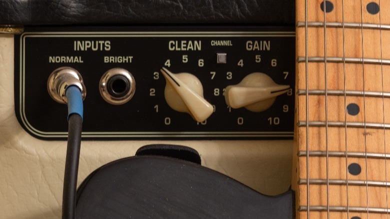 close-up of a guitar amp inputs and knobs